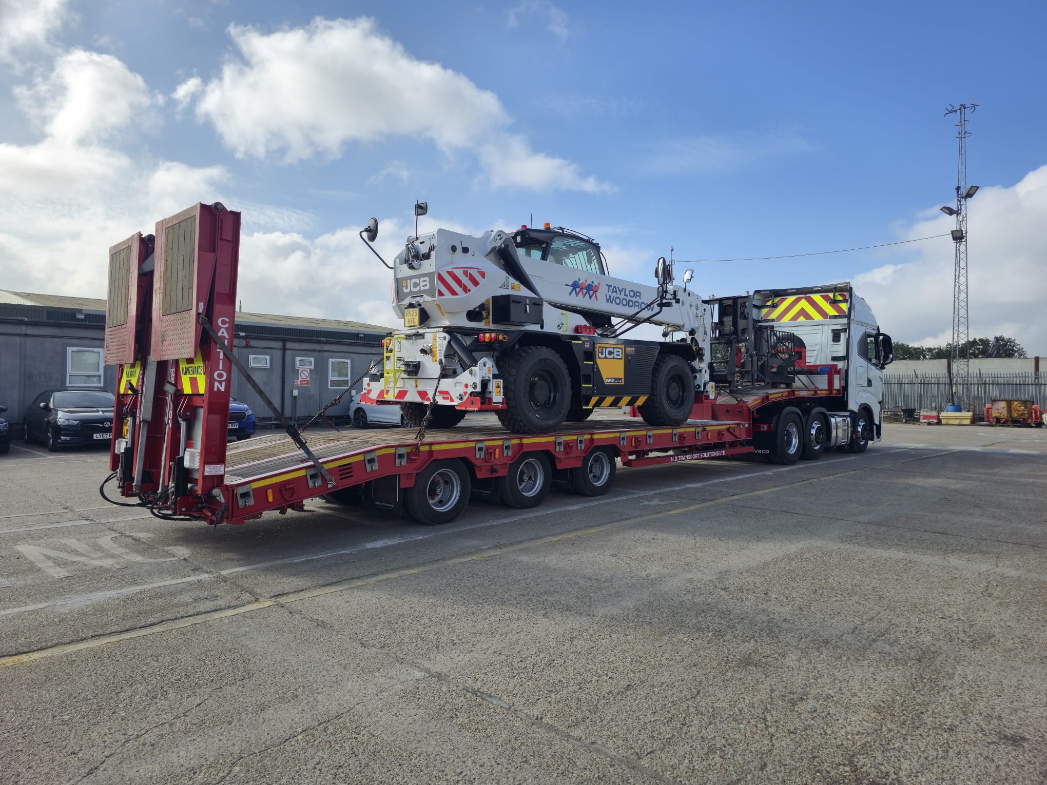 Low loader trailer carrying heavy plant